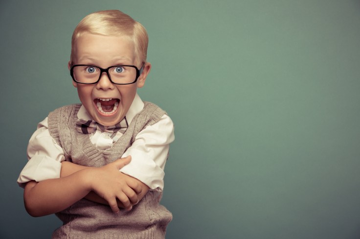 Cheerful smiling funny boy on a green background.
